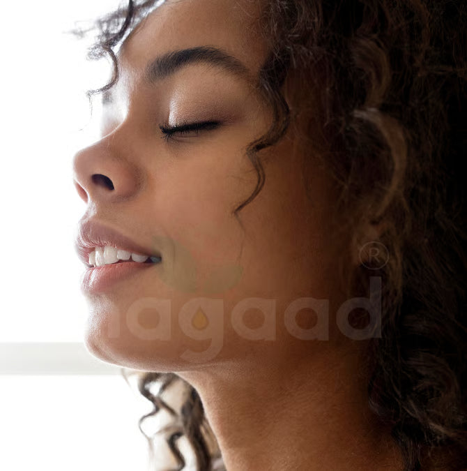 Frankincense essential oil bottle and diffuser with text overlay on a blurred background.